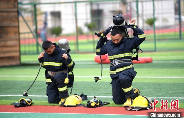 新消防員進(jìn)行穿戴空呼器展示。　劉忠俊 攝